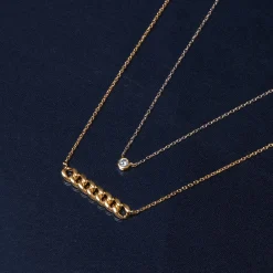 Diamond Round Solitaire Bezel-Set Pendant In 14K Yellow Gold (1/10 Ct. Tw.)