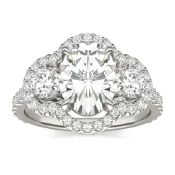 Oval Moissanite Three-Stone Ring With Halo In 14K White Gold